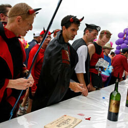 PAUILLAC, FRANCE - SEPTEMBER 06:  Runners enjoy wine at a chateau during a food and wine break in the Marathon du Medoc race on September 6, 2008 near Pauillac, France. The marathon runs through the famous Medoc wine region prior to the annual harvest.  (Photo by Denis Doyle/Getty Images)